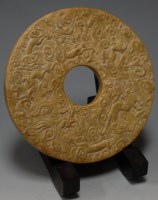 Lot 206 - A Chinese stone roundel carved with various...