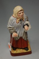 Lot 215 - A Russian painted bisque figure of an elderly...
