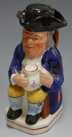 Lot 51 - *A 19th century Staffordshire toby in typical...