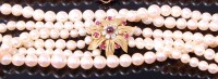 Lot 3288 - A cultured pearl triple string choker, having...