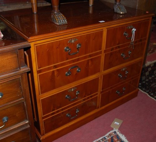 Lot 1266 - A reproduction yew wood four drawer low office...