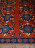 Lot 1522 - An Afghan woollen rug, the rust coloured field...