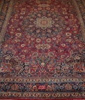 Lot 1527 - A Persian woollen Tabriz carpet, the red...