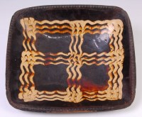 Lot 1083 - A late 18th century slipware baking dish, of...