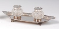Lot 1146 - A late Victorian silver inkstand, having twin...