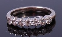 Lot 1197 - An 18ct white gold and diamond seven stone...