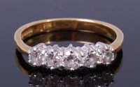 Lot 1198 - An 18ct gold and diamond five stone ring, the...