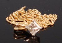 Lot 1216 - An 18ct gold and diamond set pendant, arranged...