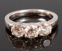 Lot 1220 - An 18ct white gold and diamond three stone...