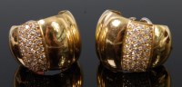 Lot 1255 - A pair of 18ct gold and diamond set ear clips,...