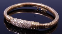 Lot 1275 - A modern yellow metal diamond set bracelet,...