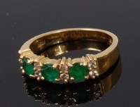 Lot 1276 - An 18ct gold, emerald and diamond dress ring,...