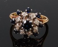 Lot 1278 - An 18ct gold, sapphire and diamond flower head...