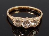 Lot 1279 - An 18ct gold and diamond three stone ring, the...