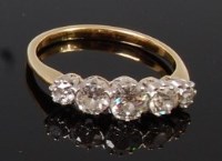 Lot 1280 - An 18ct gold and diamond five stone ring, the...