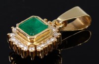 Lot 1314 - A modern 18ct gold emerald and diamond set...