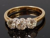 Lot 1323 - An 18ct gold and diamond three stone ring, the...