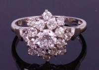 Lot 1338 - An 18ct white gold and diamond cluster ring,...