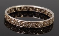 Lot 1344 - A platinum and diamond set eternity ring,...