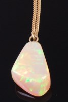 Lot 1189 - A polished opal pendant, of irregular...