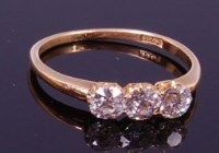 Lot 1340 - An 18ct gold and diamond three stone ring, the...