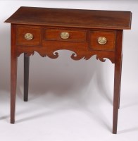 Lot 1548 - A George III mahogany lowboy, having three...