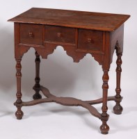 Lot 1563 - An antique oak lowboy, having three frieze...