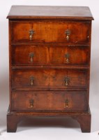 Lot 1565 - An early 20th century walnut four drawer chest,...