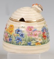 Lot 123 - A 1930s Clarice Cliff pottery honey-pot and...