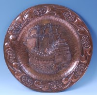 Lot 241 - John Pearson - a large embossed copper charger,...