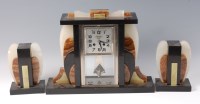 Lot 258 - An Art Deco black slate, marble and onyx clock...