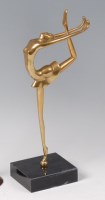 Lot 284 - A polished bronze stylised figure of a...