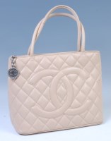 Lot 302 - A Chanel beige Caviar quilted leather...