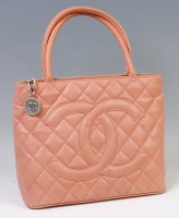 Lot 303 - A Chanel dusky pink quilted leather medallion...