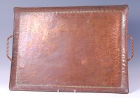 Lot 234 - An Arts & Crafts hammered copper twin handled...