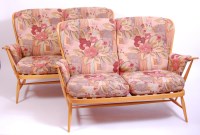 Lot 418 - A pair of Ercol blond elm stickback two-seater...