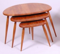 Lot 422 - An Ercol light elm nest of three 'pebble'...