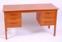 Lot 478 - A 1970s teak kneehole writing desk, of plain...