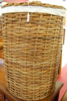 Lot 1451 - A wicker circular laundry basket and cover