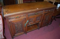 Lot 1453 - An Edwardian low relief carved walnut dresser...