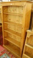 Lot 1456 - A modern freestanding pine open bookshelf,...