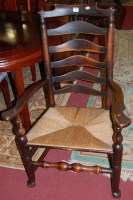 Lot 1402 - A late 19th century elm and rush seat...