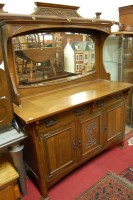 Lot 1194 - An Art Nouveau oak sideboard, having mirrored...