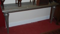 Lot 1197 - A contemporary silvered elm long console table,...