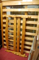 Lot 1203 - A modern pine double bedstead, having slatted...