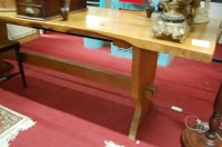 Lot 1217 - A rustic elm long trestle end refectory table,...