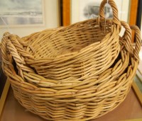 Lot 1223 - A graduated set of three wicker twin handled...