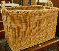 Lot 1225 - A large wicker twin handled log basket, w.81cm
