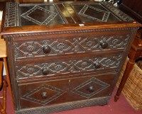 Lot 1226 - A carved oak chest having two panelled top...