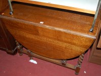 Lot 1234 - A 1920s barleytwist oak dropleaf dining table,...